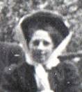A vintage photo of a group of people posing for the camera

Description automatically generated